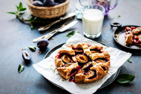 Open pie with plums and shortbread pastryの写真素材