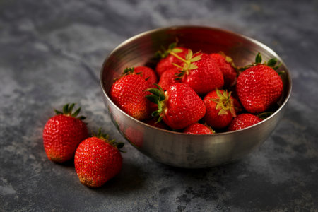 Strawberries in a Bowl, on dark backgroundの写真素材
