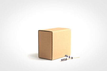 A simple, upright cardboard box with a small white label on its side, isolated on a clean white background.の写真素材