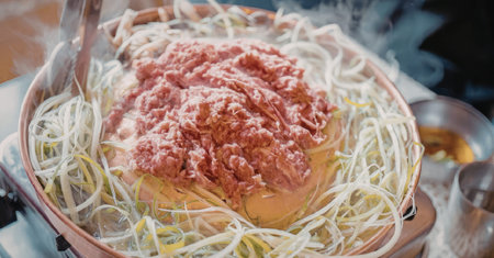 A bowl filled with sprouts and a generous serving of raw ground meat, likely prepared for a healthy and savory meal.の写真素材