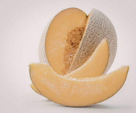 A cut melon with two slices in front and one half behind on a white background