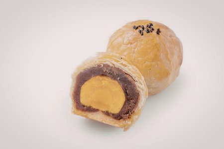 The image shows a pastry with a purple and orange filling, cut in half to reveal its contents.