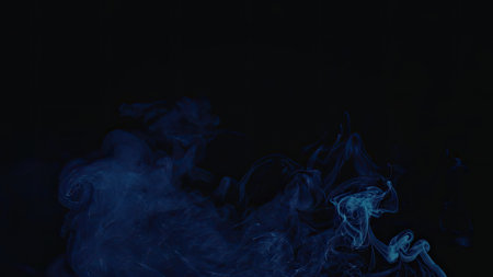 A vibrant blue smoke is swirling against a dark background, creating a mesmerizing visual effect.