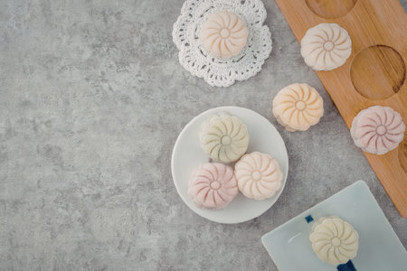 An assortment of colorful mochi desserts arranged on plates and a tray
