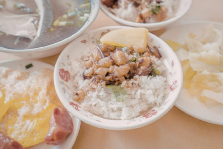 A variety of Asian dishes on a table including rice, soup, vegetables, and eggs.