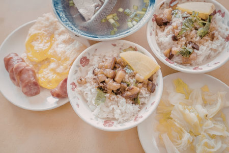 A variety of Asian dishes including rice, vegetables, and meat, presented on a table.の写真素材