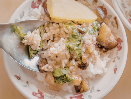 A plate of savory fried rice with herbs and a slice of lemon on top.の写真素材