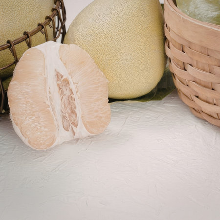 The image features a sliced fruit in the foreground with two whole green fruits behind it, one in a...