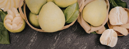 An image of green pears in baskets and sliced fruit on a marble surface