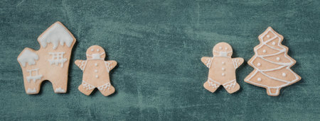 Three gingerbread cookies on a green background