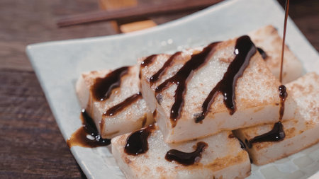A plate of grilled tofu drizzled with chocolate sauce