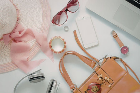 A collection of fashion accessories including a hat, sunglasses, handbag, watch, and jewelry.