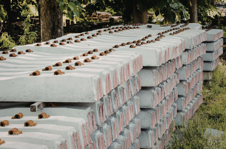 A stack of concrete blocks with red markings and brown objects on top, placed in a grassy area...
