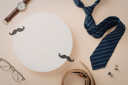 A collection of men's accessories including a tie, belt, watch, glasses, and mustaches.の写真素材