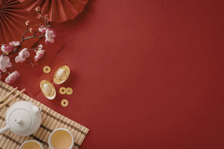 A traditional Chinese tea setting with a teapot, cups, and decorations for the New Year celebration.の写真素材