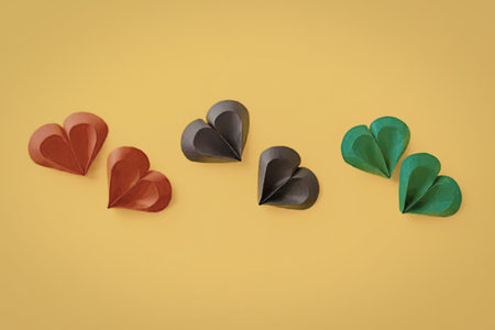 A collection of colorful hearts on a bright yellow background.