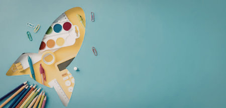 A vibrant, multicolored rocket flies through a clear blue sky, leaving a trail of colored pencils behind it.の写真素材