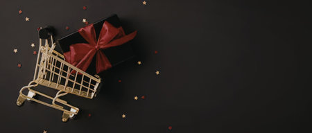 A golden shopping cart with a red gift bow on a black background with gold confetti