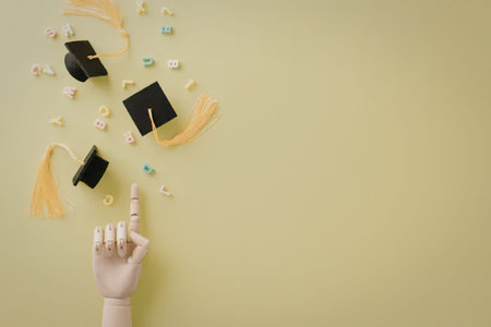A hand pointing to graduation caps and confetti floating in the air on a green background