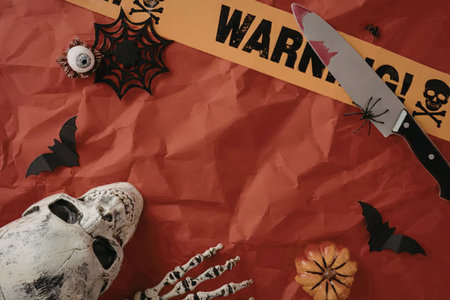 A halloween themed image with a warning sign, knife, skull, and other decorations.の写真素材