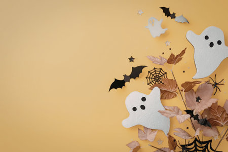 A festive Halloween arrangement featuring white ghosts, black bats, spider webs, and autumn leaves...