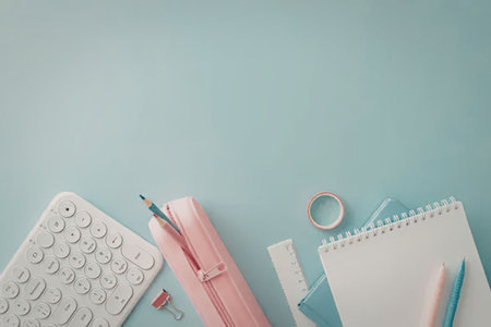 A collection of stationery items including a keyboard, pen, pencil, notebook, and paper clips...