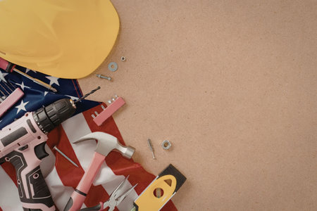 A collection of tools and a hard hat on an American flag backgroundの写真素材
