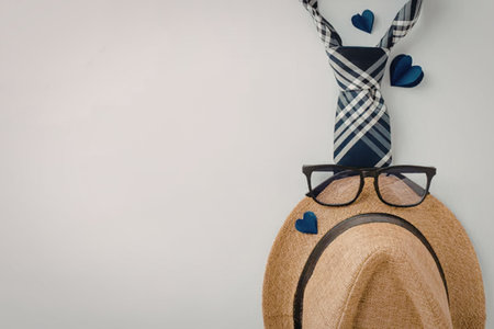 a straw hat with glasses and tie on a white background