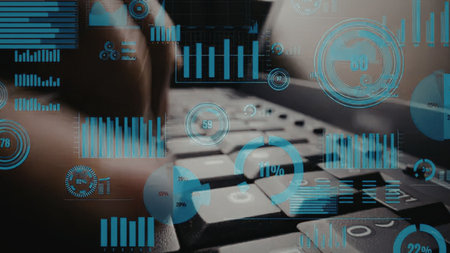 Business professional examines financial data and charts on a computer screen to gain business...