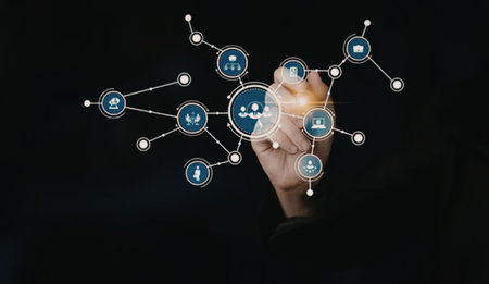 Business professional interacts with a virtual network of people and icons symbolizing connection...