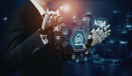 Businessman in suit interacts with robotic hand showing agile technology interface with various...