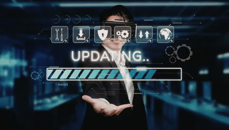 Businessman wearing virtual reality headset interacts with digital interface showing updating...