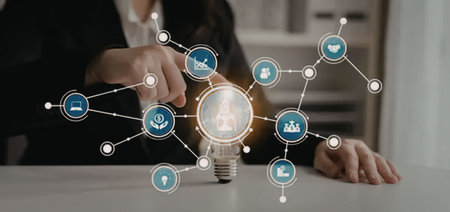 Businesswoman interacts with a virtual network around a lightbulb representing innovative ideas and...