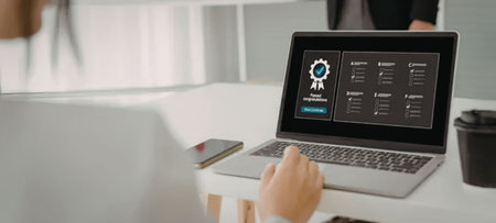 Businessman interacts with laptop displaying certification screen in a modern office setting with a...