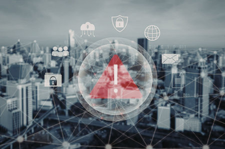 Cybersecurity threat warning notification alert sign indicating potential danger in a modern cityscape with various digital security icons surrounding the alert symbol.の写真素材