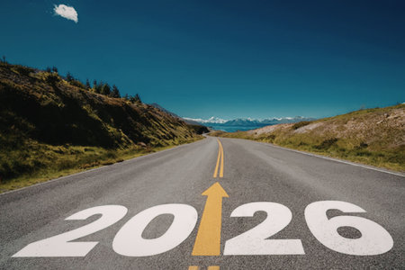 Large white numbers 2026 painted on an empty asphalt road with a yellow arrow pointing upwards...