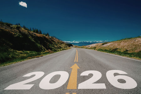 The year 2026 is painted on an empty asphalt road with a yellow arrow pointing upwards symbolizing...