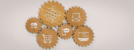 Interconnected wooden gears with icons symbolizing digital communication and e-commerce technology...