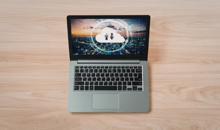 Modern laptop on a wooden desk shows cloud technology with global data transfer interface...