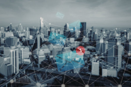 Modern cityscape with digital network overlay and abstract envelope icons representing communication and connection in a futuristic urban environment.の写真素材