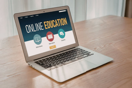 Modern laptop on a wooden table displays online education website with interactive courses and...