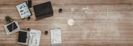 Modern office workspace featuring a laptop, documents, and analytics on a wooden desk with a global...