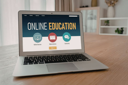 Online education website displayed on a laptop screen sitting on a wooden table in a modern room...