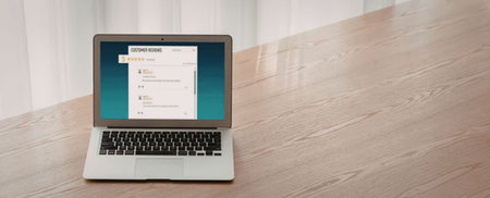 Open laptop on a wooden table displays customer reviews page with positive feedback and ratings,...