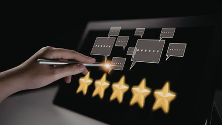 Hand interacts with digital device displaying glowing five star rating and customer feedback speech...