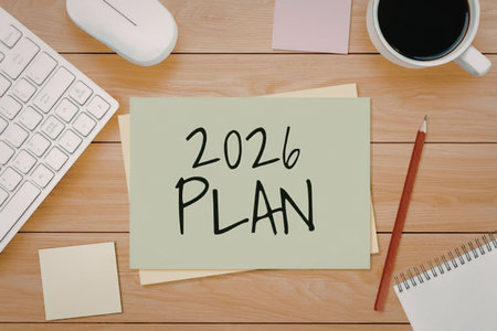 Planning for new year on desk with sticky notes and office supplies nearby always helps in staying...