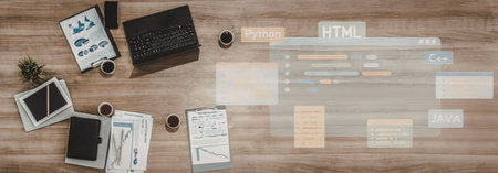 Programmer's workspace with laptop, tablet, and papers on a wooden desk surrounded by coding symbols...
