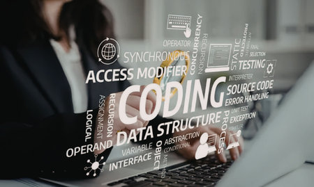 Woman in business attire works on laptop surrounded by coding terminology and software development...