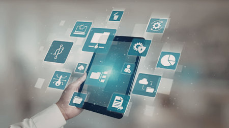 A hand holding a tablet with various technology icons floating above the screen.