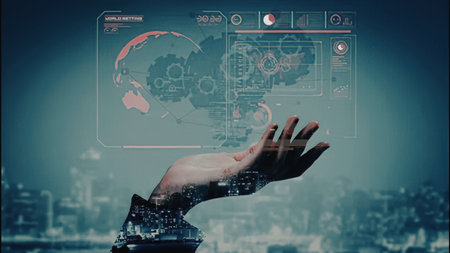 A hand reaching out to interact with a futuristic virtual interface, with a cityscape in the background.の写真素材